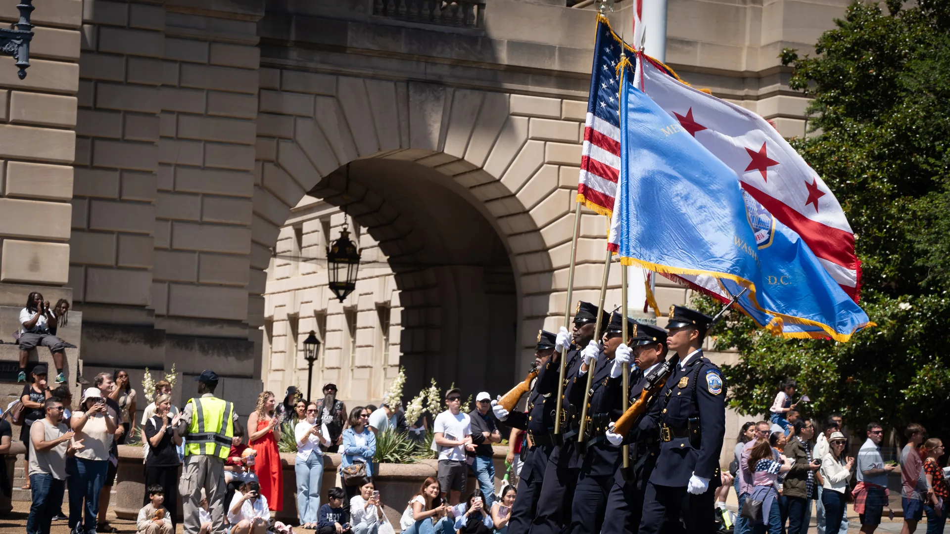 Color guard marching with flags at National Memorial Day Parade.