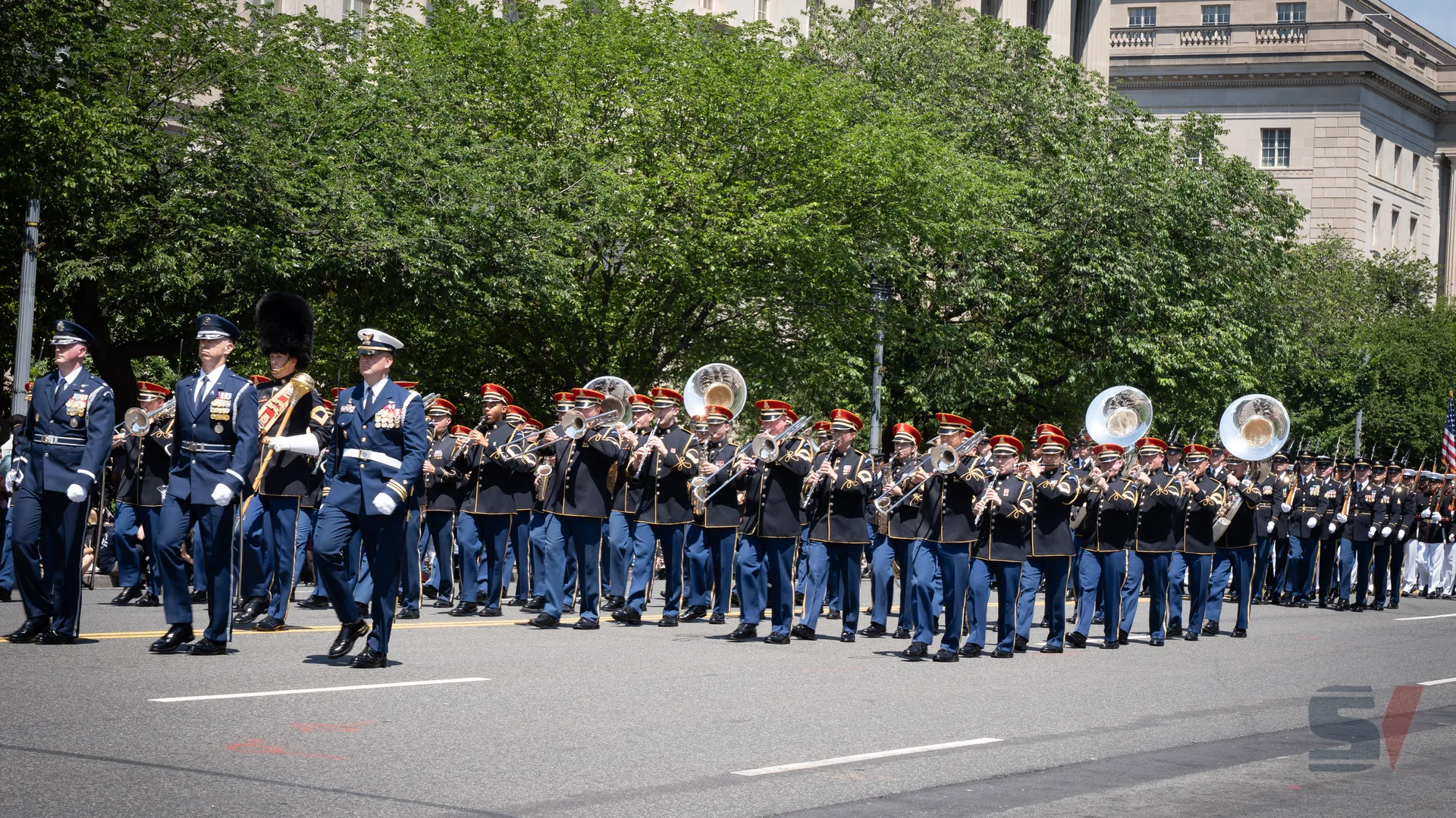 Military band marching in formation during the National Memorial Day Parade.