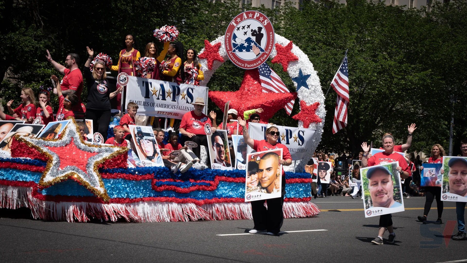 Participants on a colorful float representing TAPS at the Memorial Day Parade.
