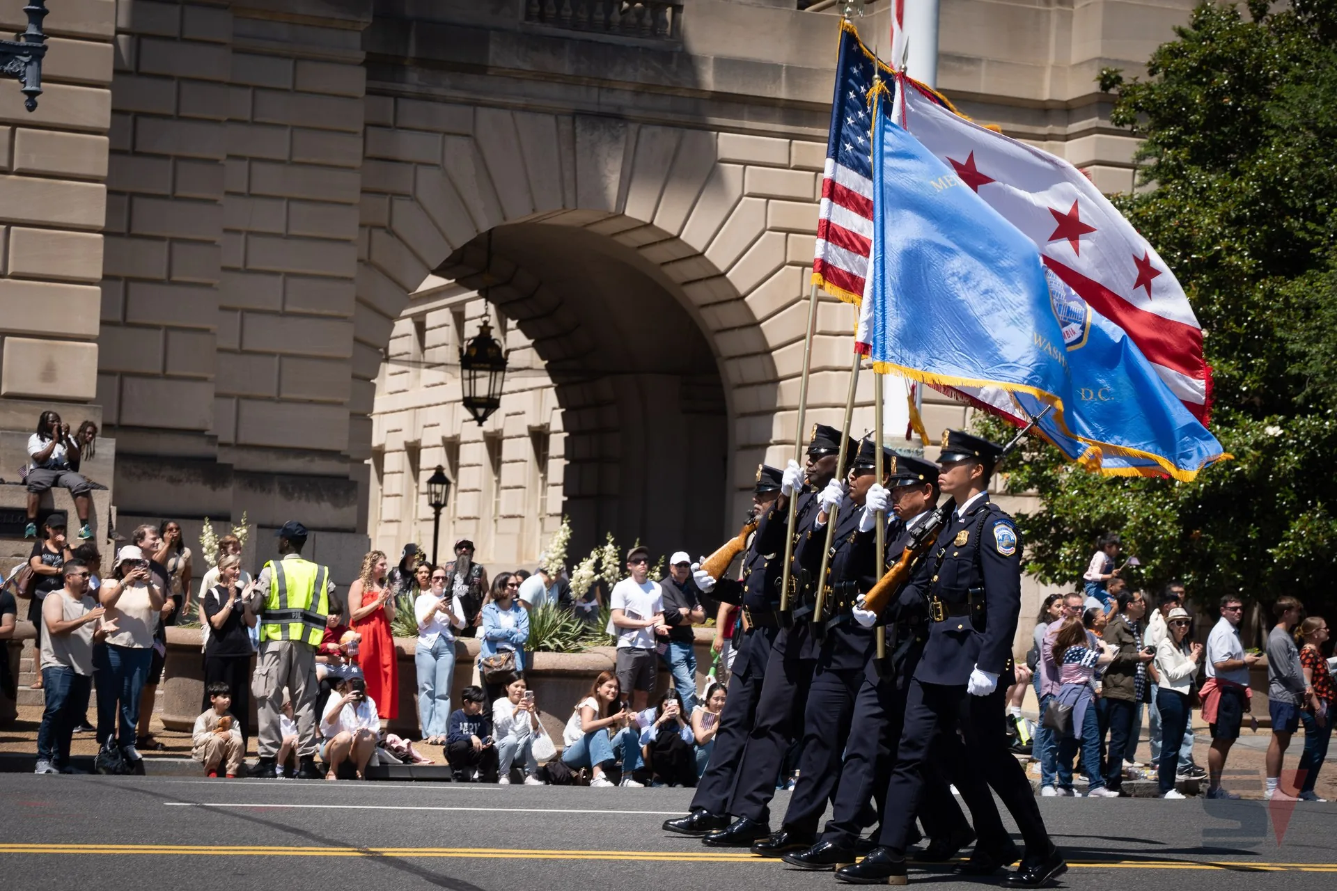 Color guard marching with flags at National Memorial Day Parade.
