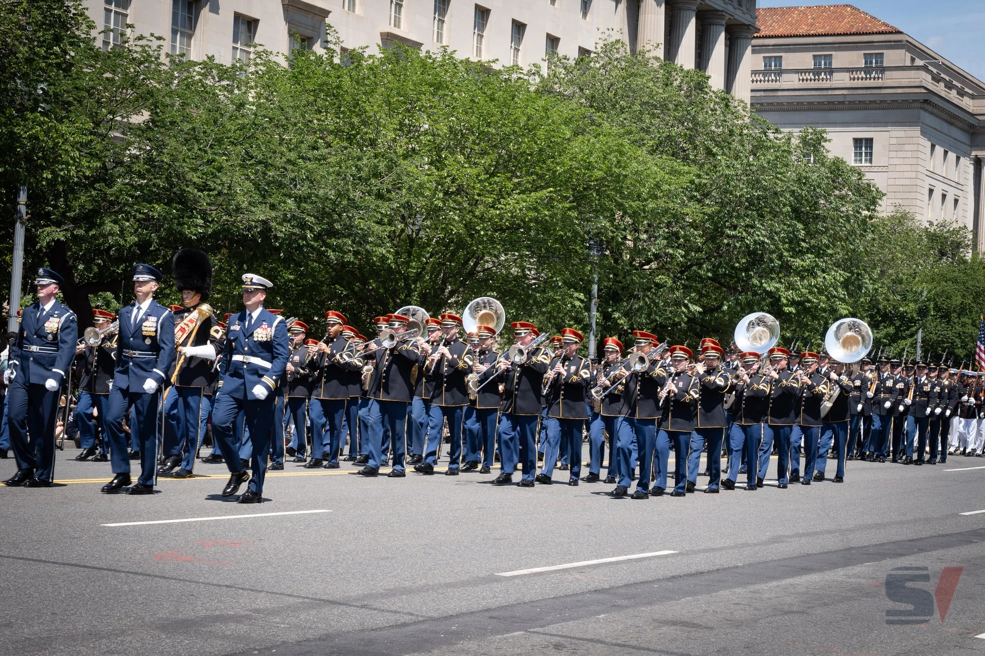 Military band marching in formation during the National Memorial Day Parade.