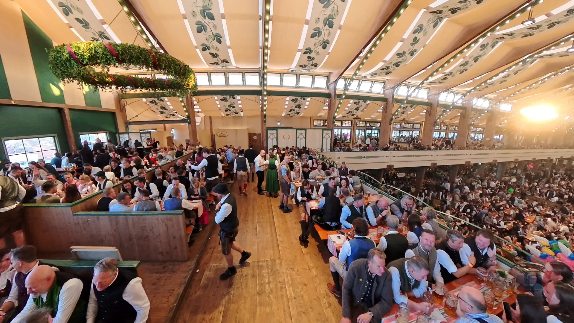 Crowd enjoying Oktoberfest inside Bräurosl tent in Munich.