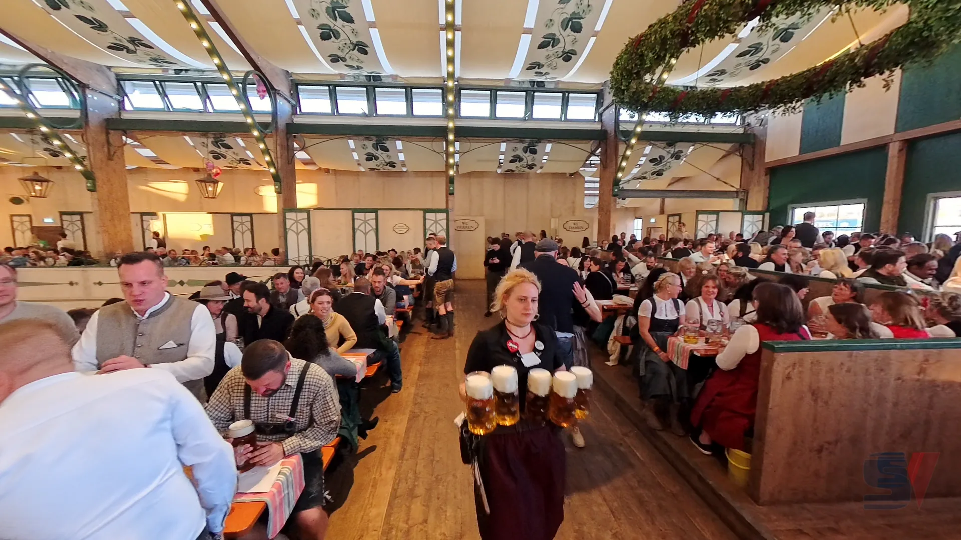 Crowd enjoying Oktoberfest inside Bräurosl tent in Munich.