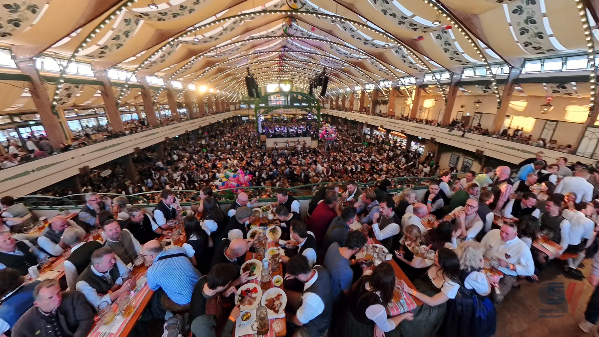 Aerial view of a crowded Bräurosl tent at Oktoberfest in Munich.