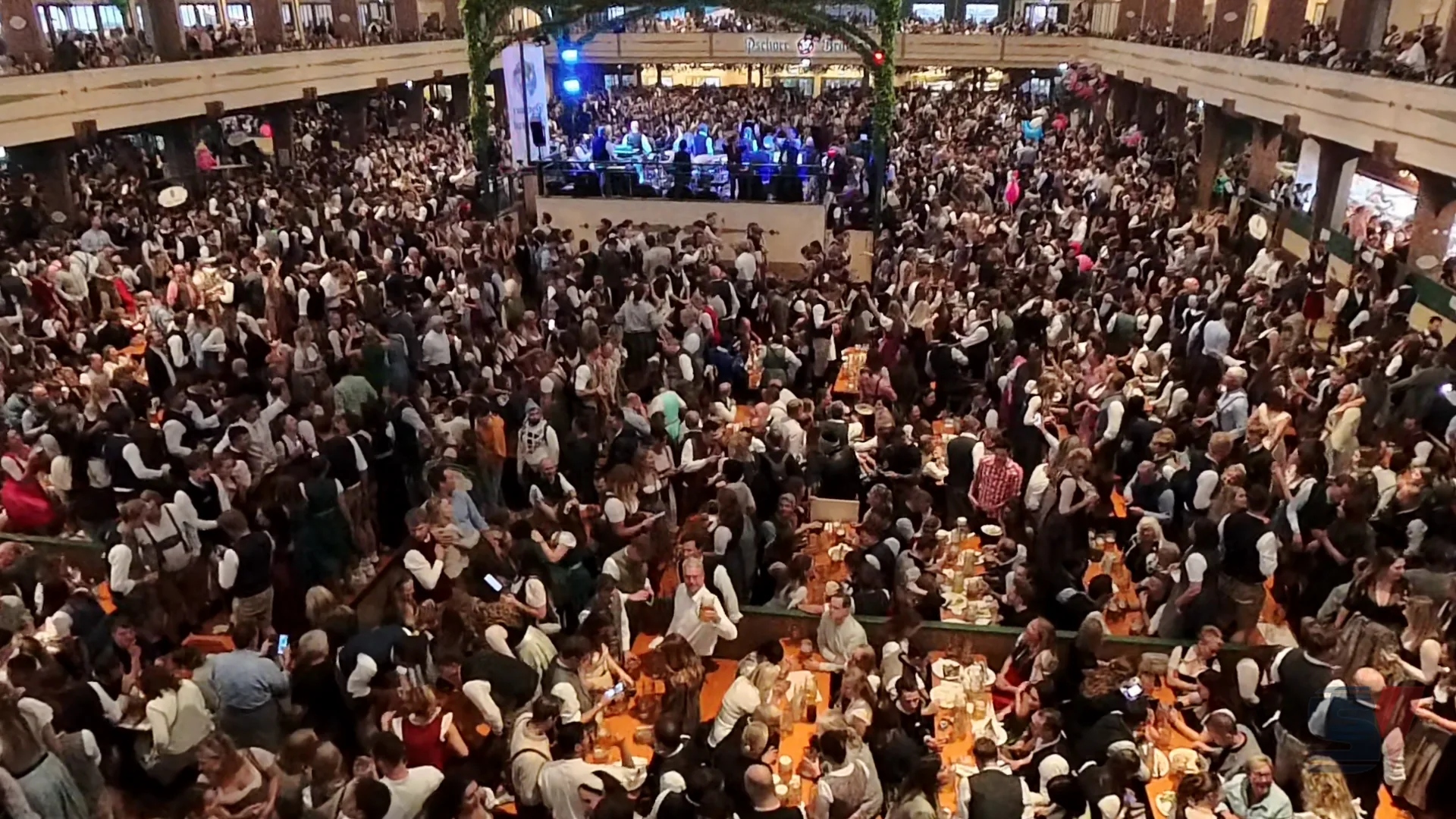 A bustling crowd enjoying Oktoberfest inside Bräurosl Tent.