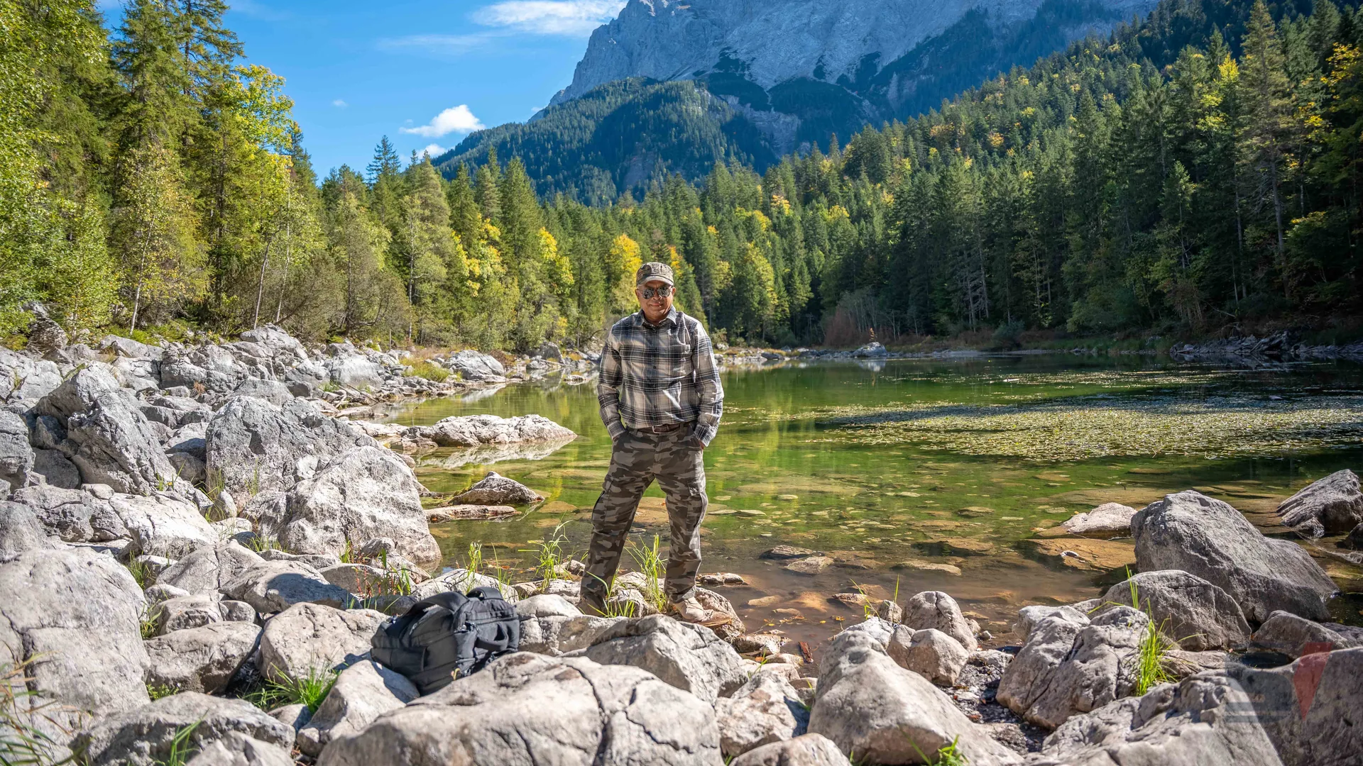 Author standing by Eibsee Lake surrounded by nature.