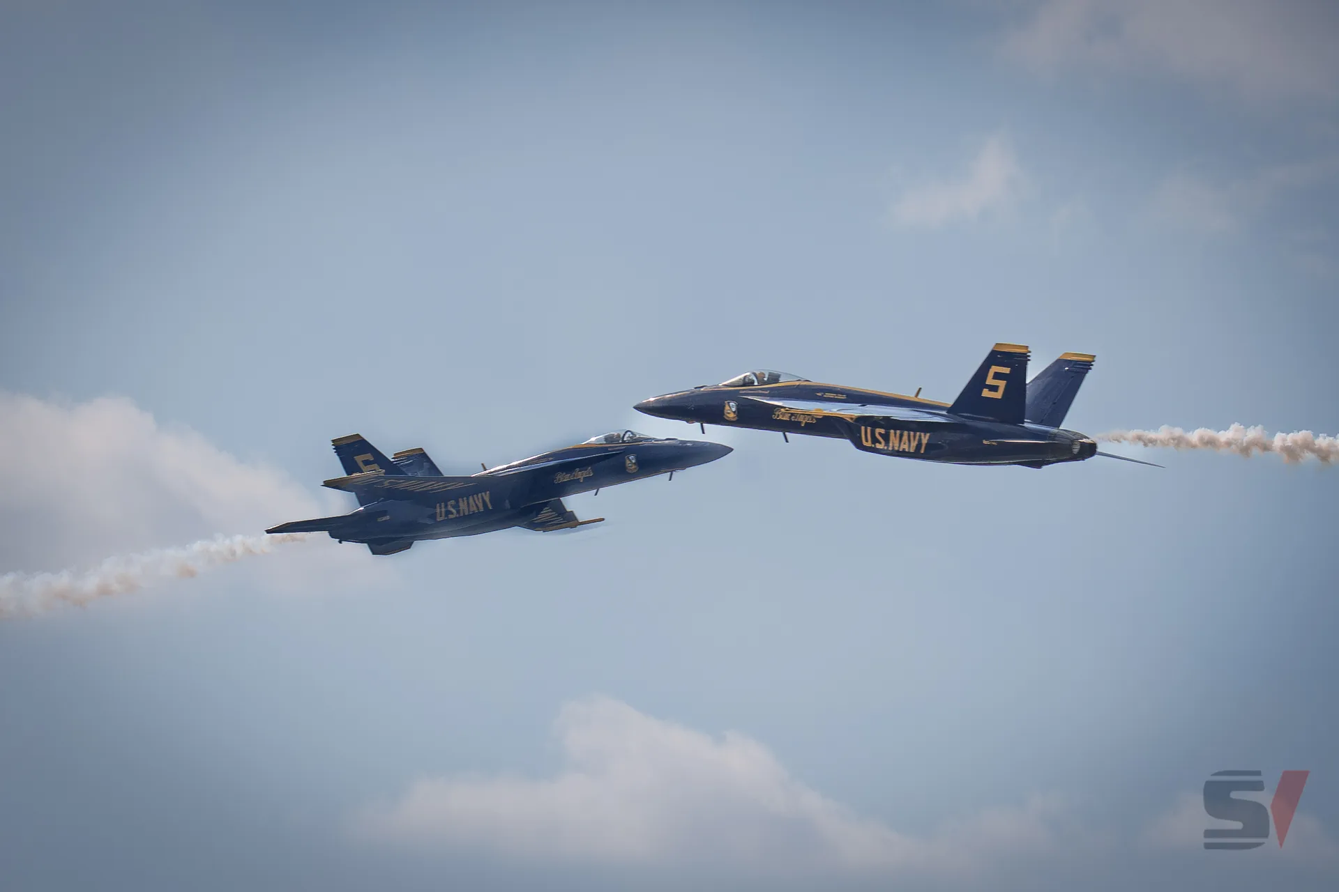 Two Blue Angels jets flying in close formation at the NAS Oceana Air Show.